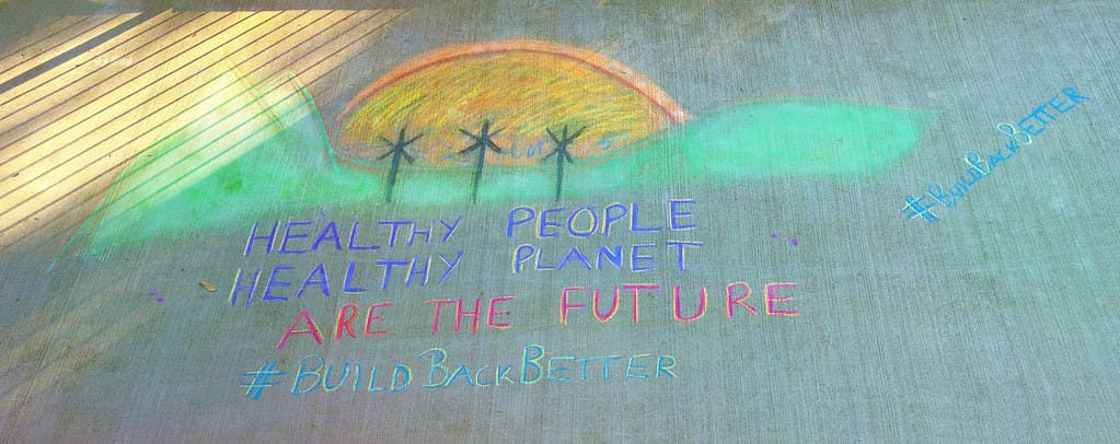 healthy people, making powerful purchasing decisions, create a healthy planet chalk sign on ground