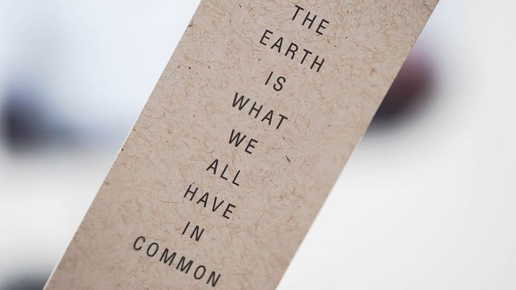 Text on recycled paper indicating that "the earth is what we have in common"