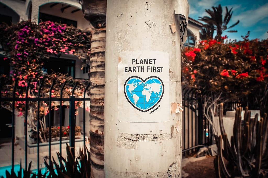 Planet Earth First signage for Earth Day on a gray post outdoors