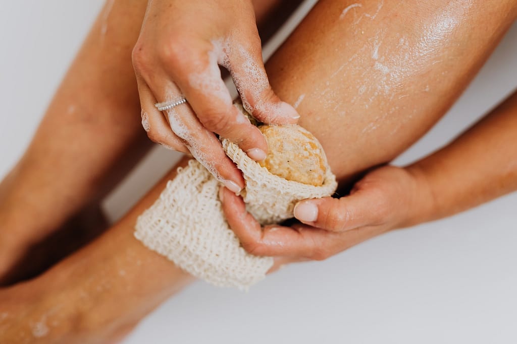 homegrown loofah sponge being used to wash legs