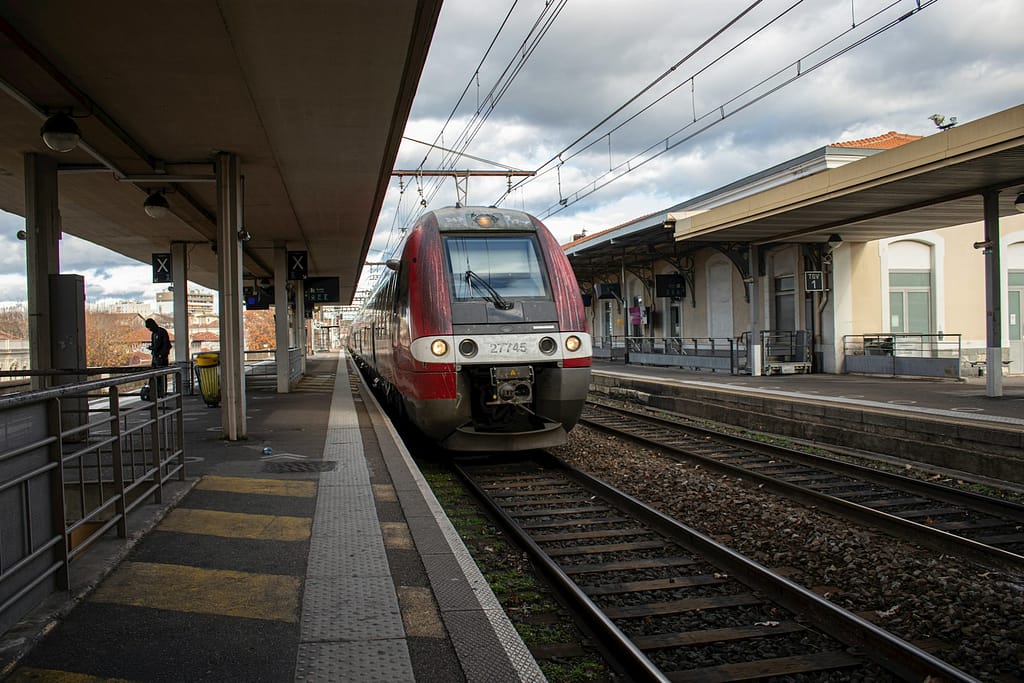 a public train entering a station as a sustainable transportation option