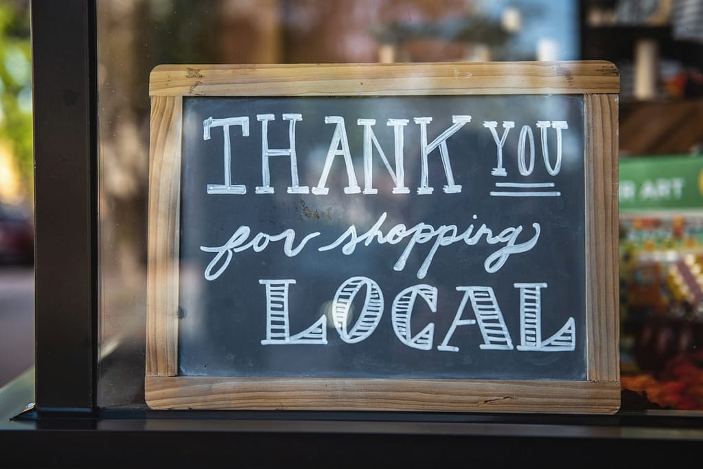 shallow focus photo of thank you for shopping local signage