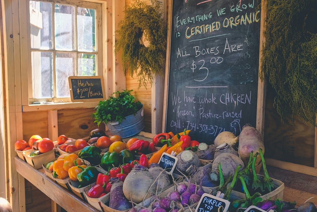 variety of local vegetables displayed with Certified Organic signage