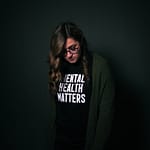 woman in black and white long sleeve shirt that says mental health matters