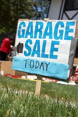 Garage Sale sign on lawn to get rid of clutter sustainably