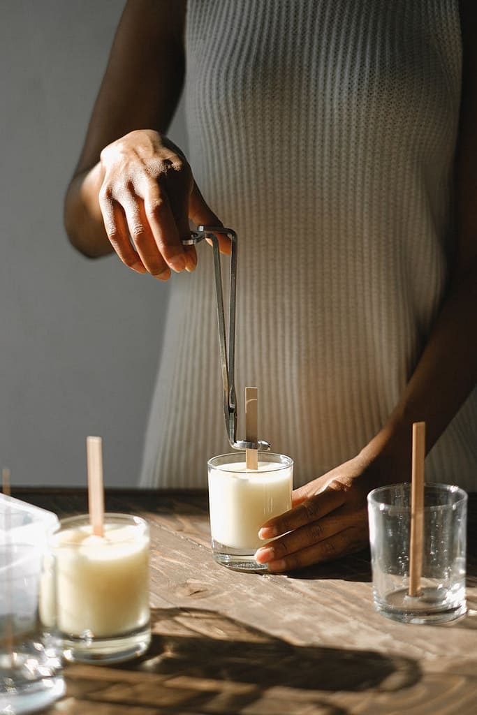woman making all natural candles with wooden wick