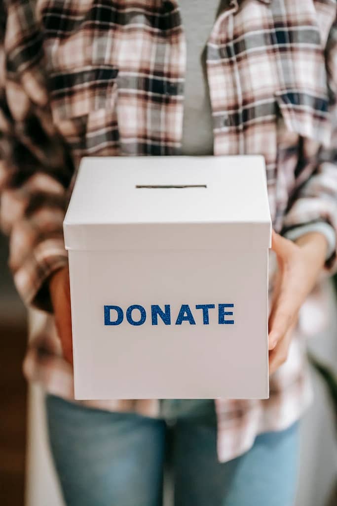 person showing donation box to get rid of clutter in home