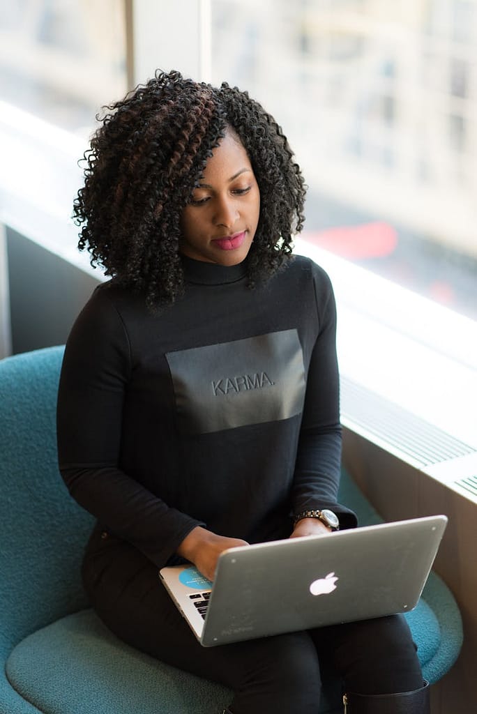 Woman in Black Long-sleeved Shirt Using Laptop